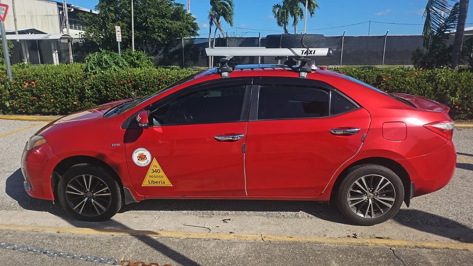 Licensed red sedan taxi in Liberia, Guanacaste